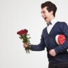 cheerful-gentleman-with-flowers-and-gift-box