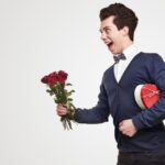 cheerful-gentleman-with-flowers-and-gift-box