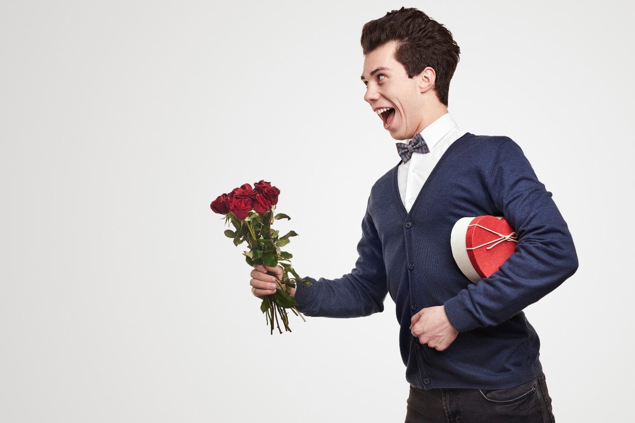 cheerful-gentleman-with-flowers-and-gift-box